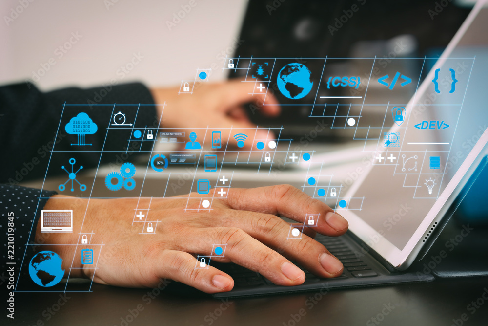 Poster close up of businessman hand working with laptop and digital docking keyboard tablet computer in modern office