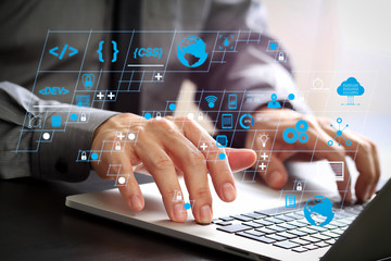 close up of businessman working with laptop computer on wooden desk in modern office
