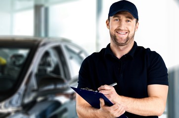 Delivery man with clipboard on light background