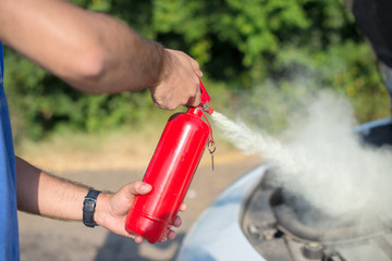 Man using car to extinguish a car fire