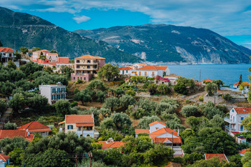 Fototapeta na wymiar Cozy town, relaxing, summer feeling. Red roofs of Assos village at the lush green Mediterranean place of Kefalonia Island