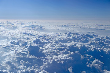 Flight over clouds. Wonderful panorama from window of plane with white clouds