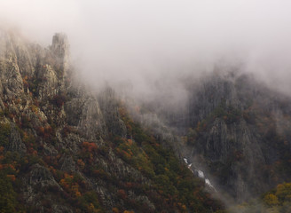 Waterfall in Autumn at the Rhodope mountain range.The mountain is covered with fog