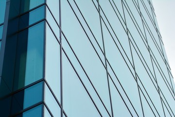 Abstract fragment of contemporary architecture, walls made of glass and concrete. Glass curtain wall of modern office building