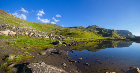 Mountain lake reflection of the Edelweissspitze viewing point and the High Tauern Road in Eastern Tyrol