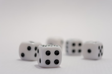 White dice with black dots on white background