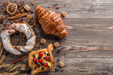 Sweet flour products, raw sugar cubes, cinnamon and dried seeds. Flat lay and space for writing