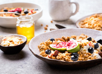 Muesli with Nuts Yogurt and fresh Figs Blueberry on the gray Background.Granola Healthy Breakfast. Sweet food Dessert. Snack  Dry Diet Nutrition Concept.