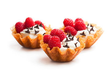 Brandy  snap baskets with ice cream and berries isolated on white