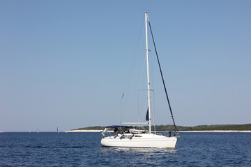 Sail boat on blue water