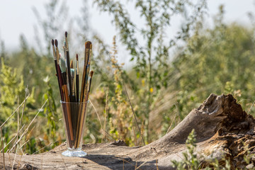 Brushes artist in a glass vase.
