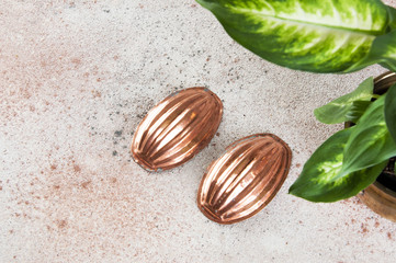 Vintage copper molds on a concrete background.