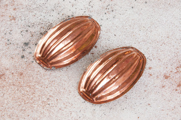 Vintage copper molds on a concrete background.