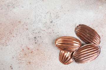 Vintage copper molds on a concrete background.
