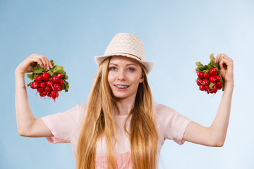 Happy woman holding radish