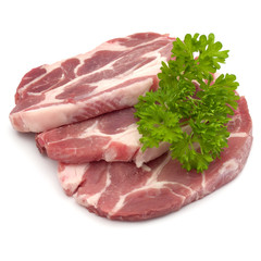 Raw pork neck chop meat with parsley herb leaves garnish isolated on white background cutout