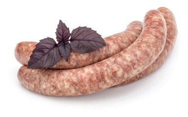 Raw sausage with basil leaf isolated on white background