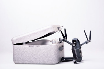 drone opens the case where lies another drone on a white background