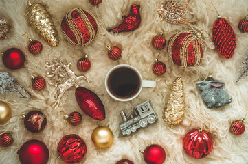 Hot tea and Christmas toys on a warm background of natural warm sheepskins. New Year 2019 composition Christmas festive still life