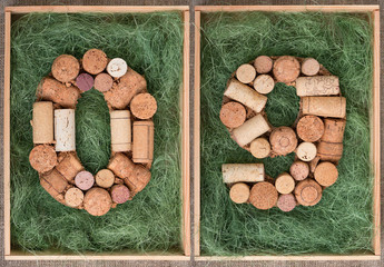Number 09 zero nine made of wine corks on green background in wooden box