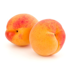 Two apricot fruit isolated on white background cutout
