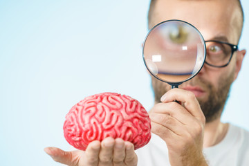 Man looking at human brain