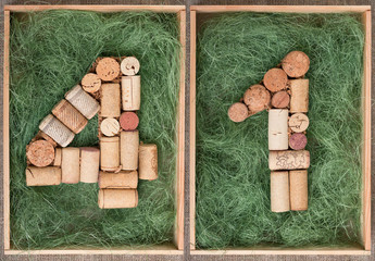 Number 41 forty one  made of wine corks on green background in wooden box - obrazy, fototapety, plakaty