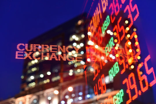 currency exchange rate in reflection of blurry background of business center