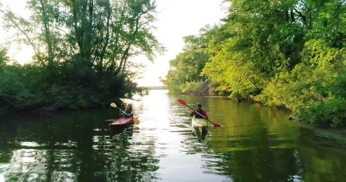 Two kayaks with people on the scenic river