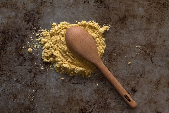 Ground Yellow Mustard Spilled from a Teaspoon