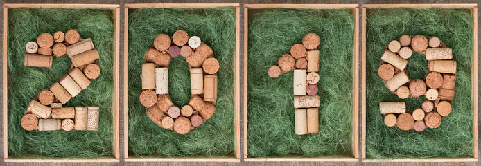 2019 New year numbers made of wine corks on green background in wooden box  Banner