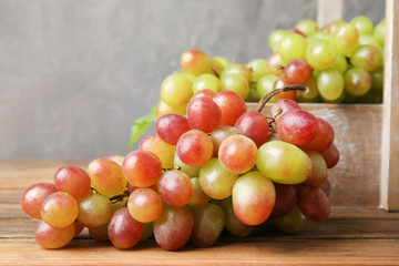 Fresh ripe juicy grapes on table against blurred background