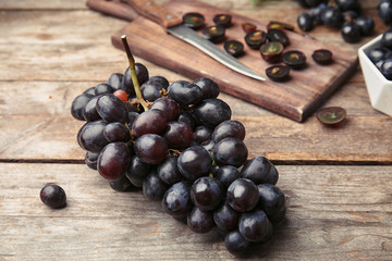 Fresh ripe juicy grapes on wooden table