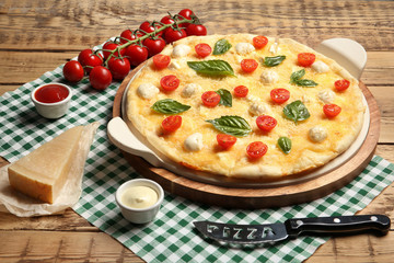 Composition with tasty homemade pizza on wooden table