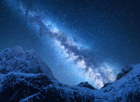 Milky Way above snowy mountains. Space. Fantastic view with snow covered rocks and starry sky at night in Nepal. Mountain ridge and sky with stars in Himalayas. Landscape with bright milky way. Galaxy