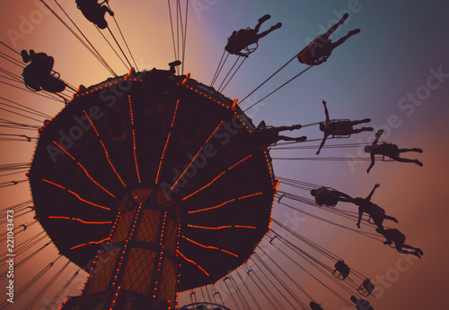 Beautiful Fair Sunset Photo Of A Swing Ride Full Of People