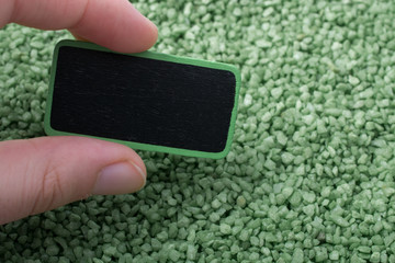 Noticeboard with frame on green color sand