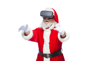 Christmas. Santa Claus in black virtual reality glasses makes gestures with his hands. Surprise, emotion. New technology. Isolated on white background.