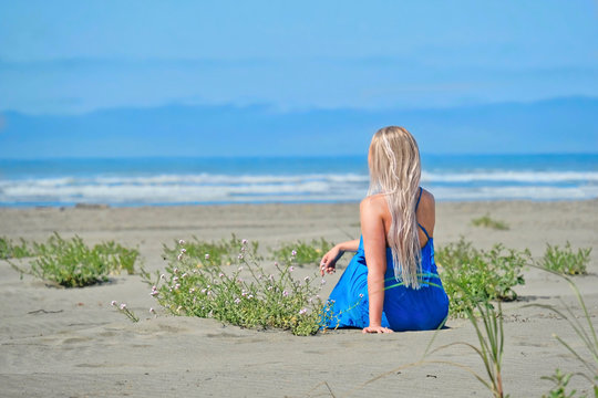 Summer vacation on beach. Woman on beach looking at the sea. Seashore Olympic peninsula. Olympic National Park.  La Push. Washington. United States of America.