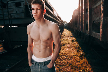 Sports guy in nature near the trains.Pumped guy.Sports guy