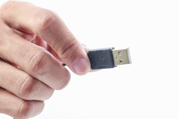Man hand holding usb cable
