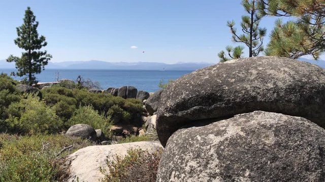 A wide picturesque establishing shot of Lake Tahoe, California on a sunny summer day.  	