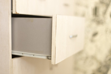 cupboard with opened empty drawer