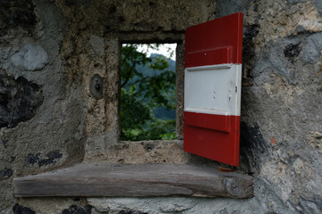 red window in brick wall