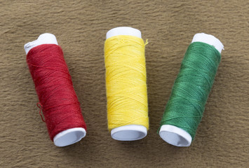 Several bobbins on a background of brown cloth