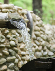 water flows from a pipe or water gushing out of the pipe close up