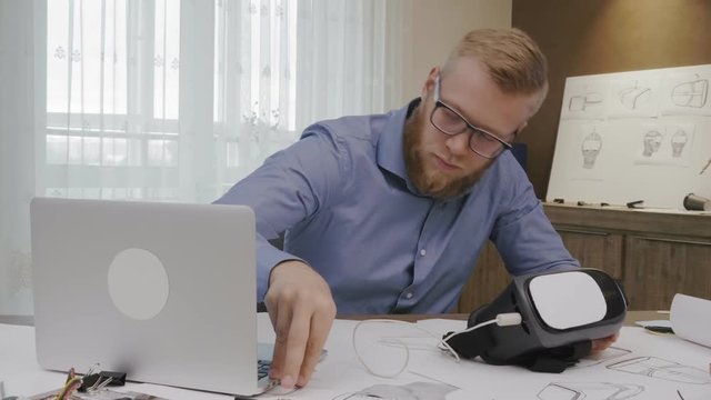 Software engineer programming VR headset