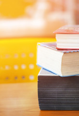 Book stack in the library room on wood desk and selective focus for business and education background, back to school concept