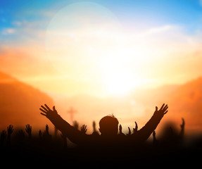 Praise and worship concept:Silhouette of Christian prayers raising hand while praying to the Jesus - obrazy, fototapety, plakaty