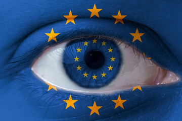 Human face painted with flag of European Union EU on the face and the iris. The concept of the...